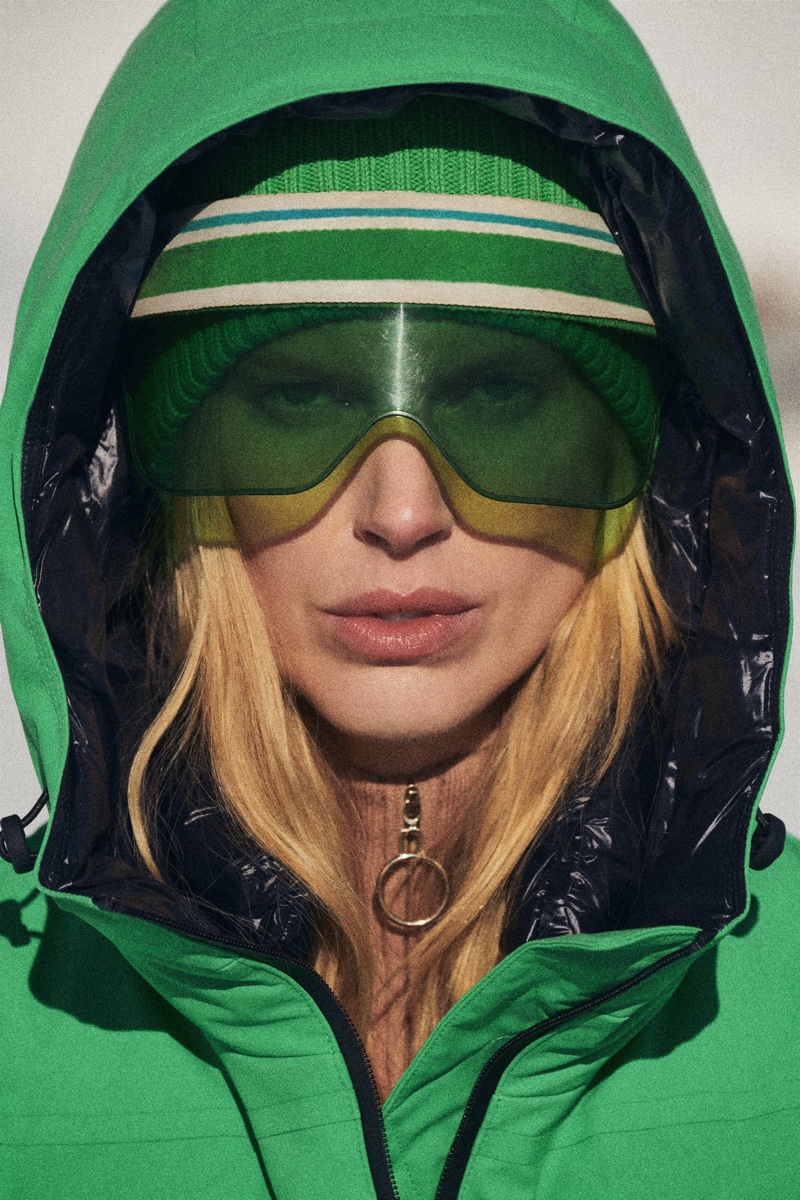 Zara Ski Collection shows green down coat puffer jacket with matching goggles.