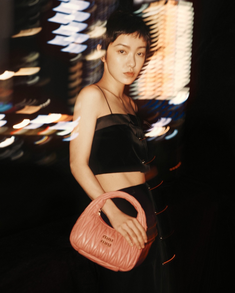 Amber Kuo poses with Miu Wander bag for Miu Miu Lunar New Year 2023 campaign.