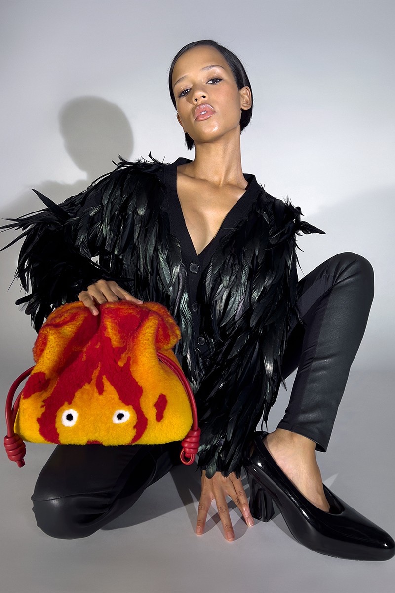 Posing with a fire bag, Taylor Russell fronts LOEWE x Howl's Moving Castle collection campaign.