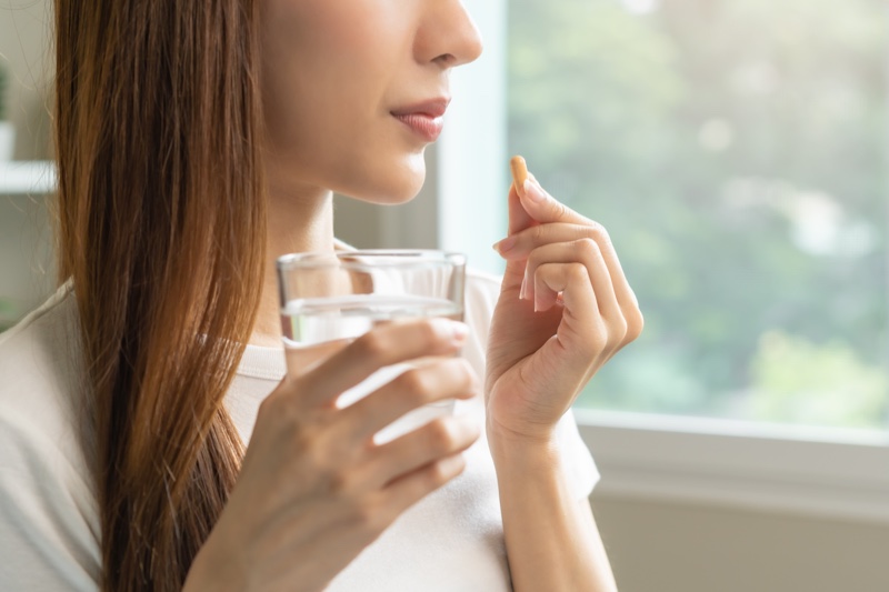 Woman Taking Supplement