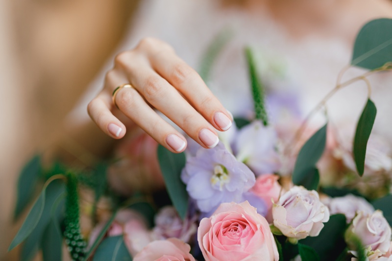 Womans Hand Gold Wedding Ring Flowers