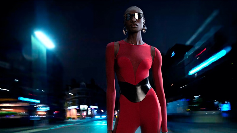 Model Nyagua poses in red catsuit for Alexander McQueen spring-summer 2023 campaign.