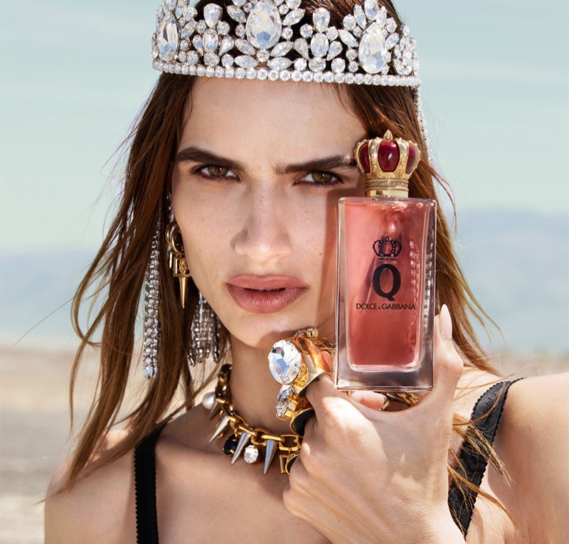 Model Linda Helena poses with Dolce & Gabbana Q fragrance bottle.