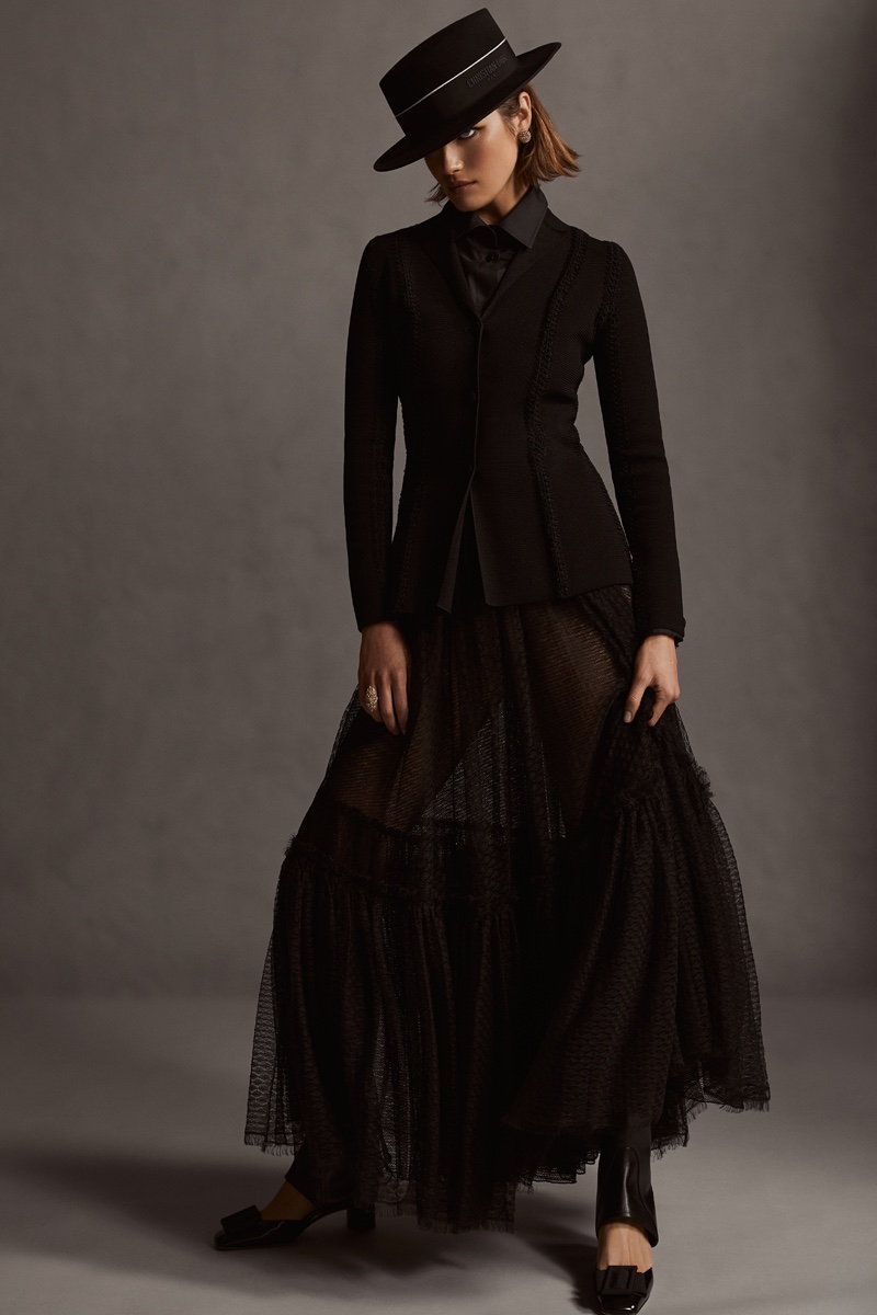 Bar Jacket in Black Technical Mesh, £3,500.00, Blouse in Black Cotton Poplin, £1,450.00, Flared Mid-Length Skirt in Black Plumetis Tulle, £3,600.00, Dior Epique Gaiter in Black Calfskin, £1,150.00, Dior Idylle Ballet Pump in Black Patent Calfskin and Grosgrain, £790.00, Diorodeo Small Brin Hat in Black Rabbit Felt, £800.00, All by Dior.