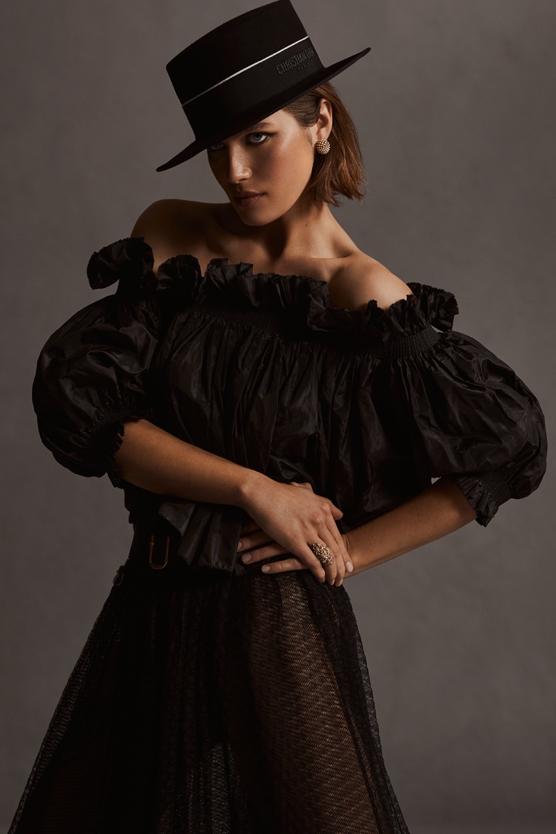 Off-The-Shoulder Smocked Top in Black Silk Taffeta, £2,350.00, Flared Mid-Length Skirt in Black Plumetis Tulle, £3,600.00, Diorodeo Small Brin Hat in Black Rabbit Felt, £800.00, Dior Tribales Earrings, £590.00, Dior Granville Ring, £530.00, All by Dior.