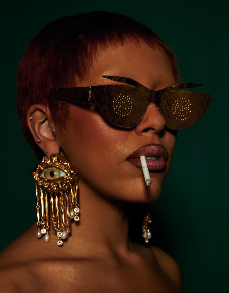 Doja Cat gets her closeup in Schiaparelli sunglasses and earrings.