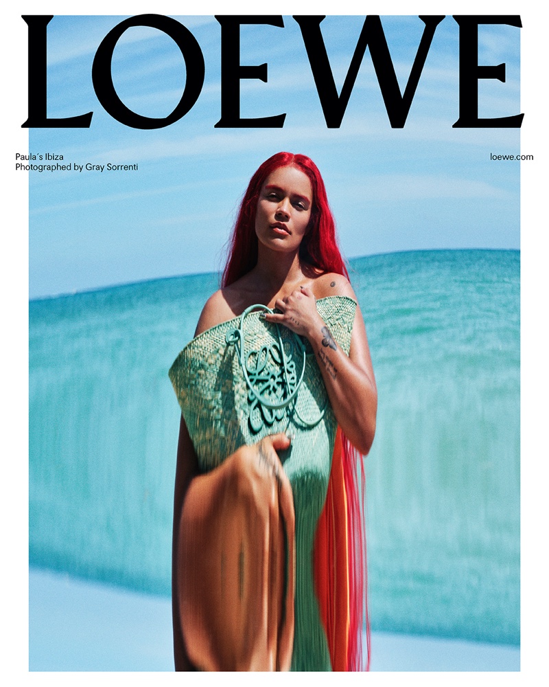 Singer Karol G models anagram basket bag from LOEWE Paula's Ibiza 2023 collection campaign.