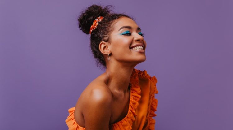 Black Woman Smiling Orange Top Summer Makeup
