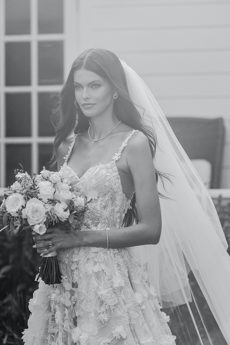The intricate floral detailing on Kamila Hansen's Galia Lahav dress adds an enchanting touch to her wedding look.
