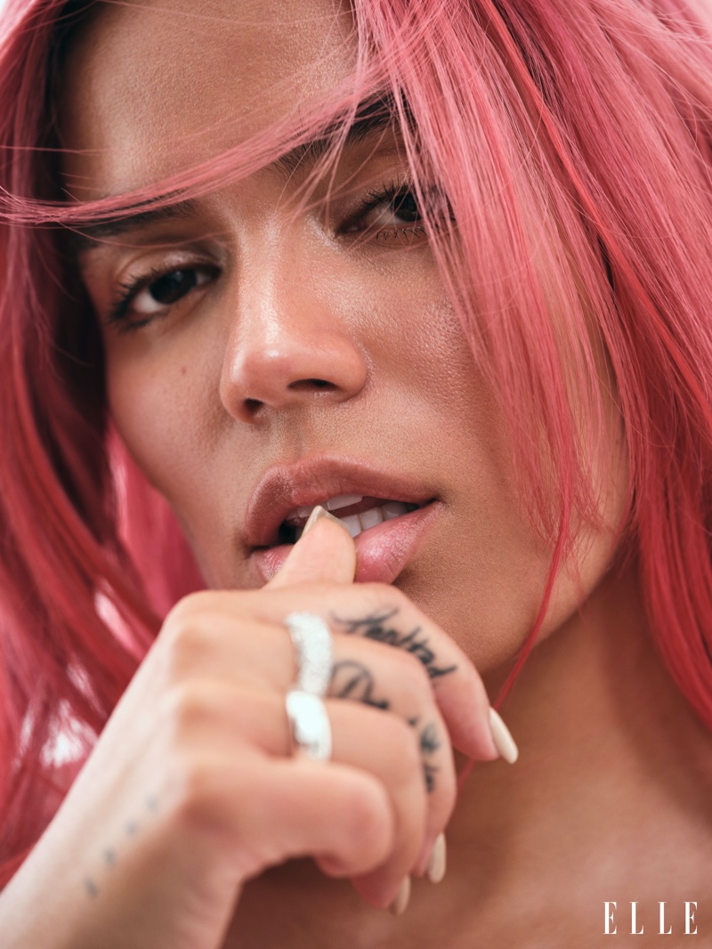 Singer Karol G shows off pink hair in the photoshoot.