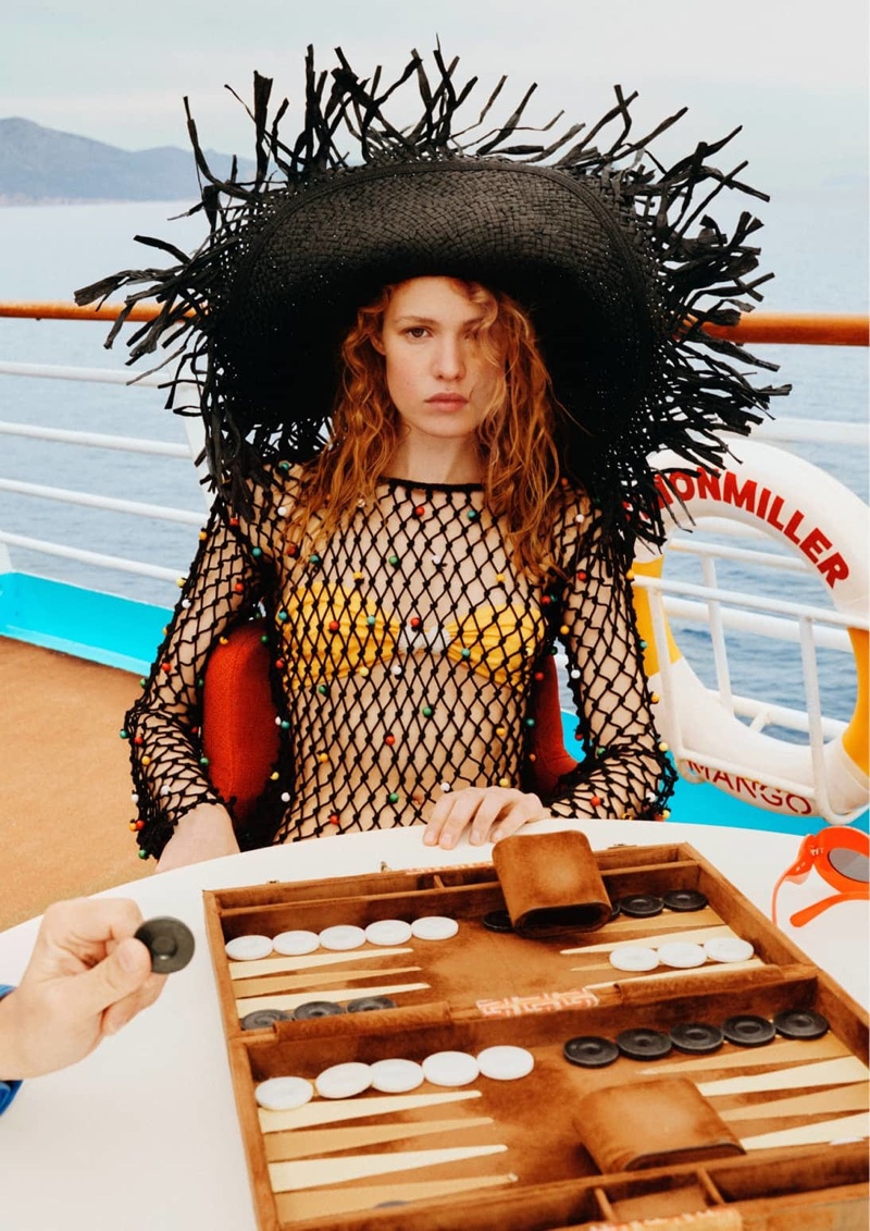 Liv Walters poses in sun hat for Mango x Simon Miller summer 2023 collection campaign.