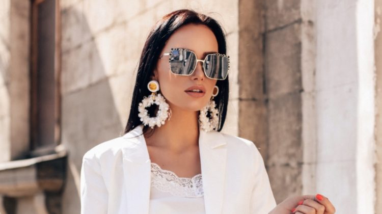 Woman Luxurious White Suit Oversized Statement Earrings Sunglasses
