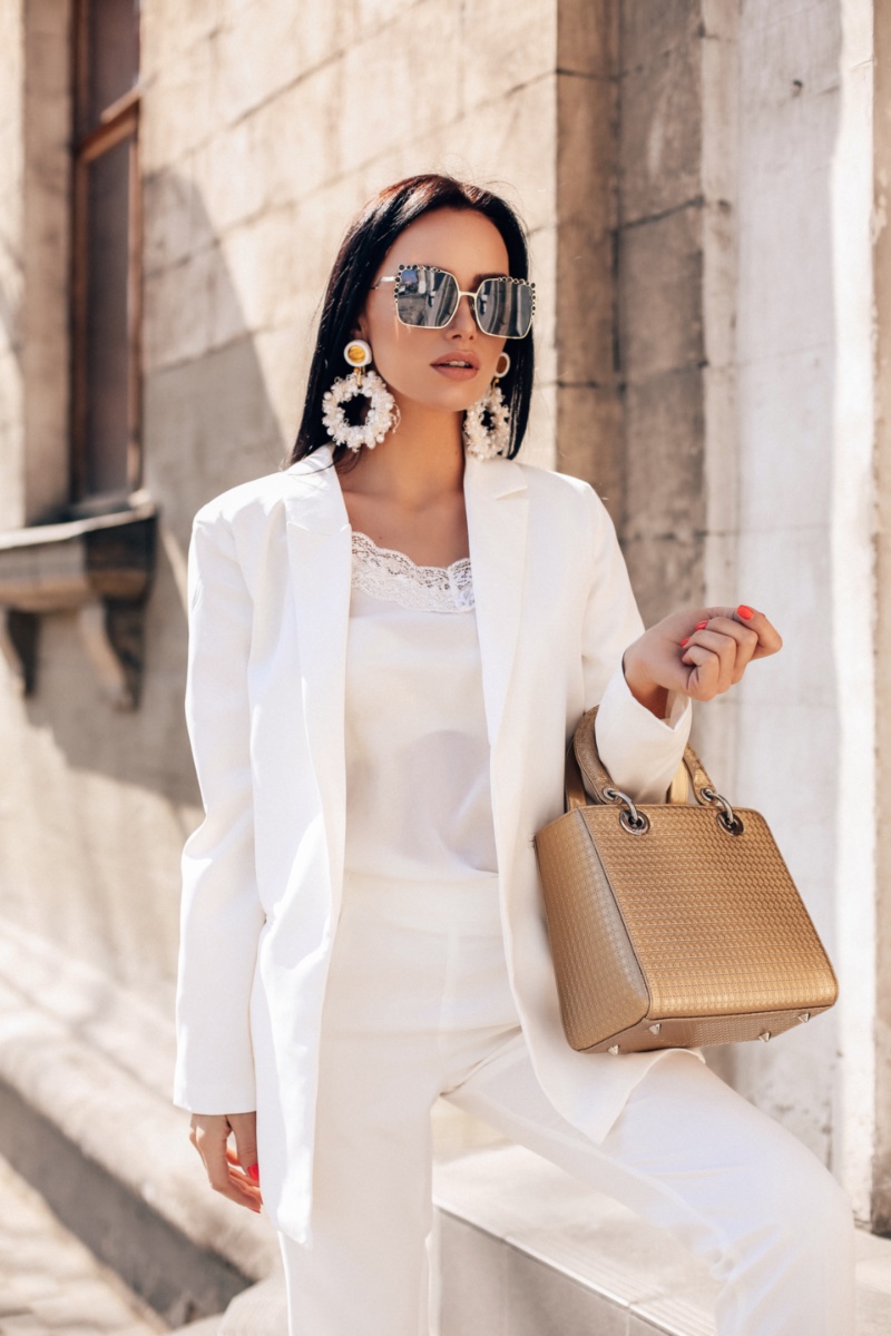 Woman Luxurious White Suit Oversized Statement Earrings Sunglasses