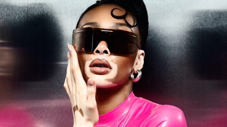 Winnie Harlow wears pink DSquared2 top with Nike sunglasses.