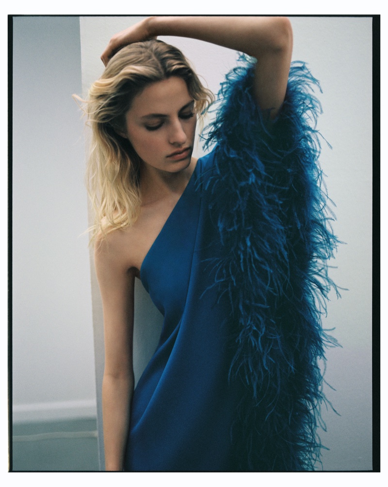 Felice Noordhoff wears feathered asymmetrical dress from Mango Capsule summer 2023 collection.