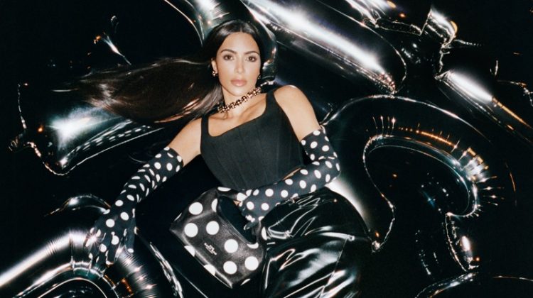 Dressed in black, Kim Kardashian poses on an inflatable set for Marc Jacobs' new campaign for fall 2023.