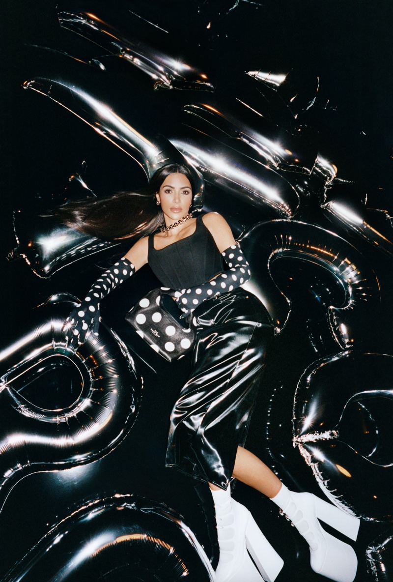 Dressed in black, Kim Kardashian poses on an inflatable set for Marc Jacobs' new campaign for fall 2023.