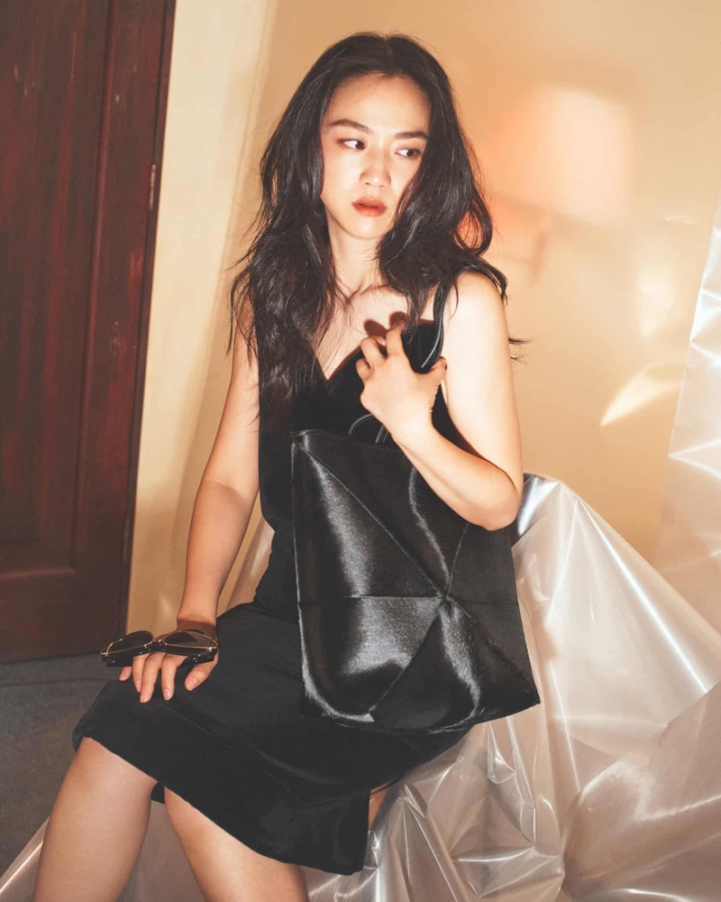 Wearing a little black dress, Tang Wei fronts Loewe fall 2023 campaign.