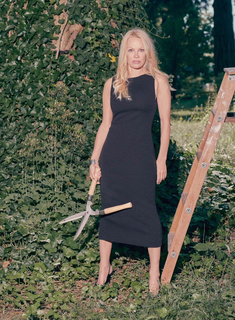 Wearing a black dress, Pamela Anderson appears in the Aritzia Babaton collection.