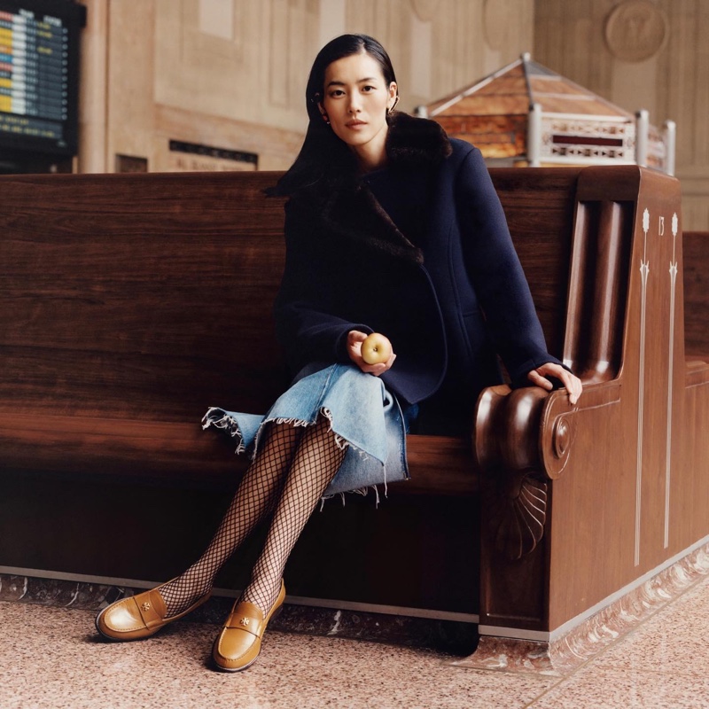 Liu Wen poses at a train station for Tory Burch fall-winter 2023 campaign.