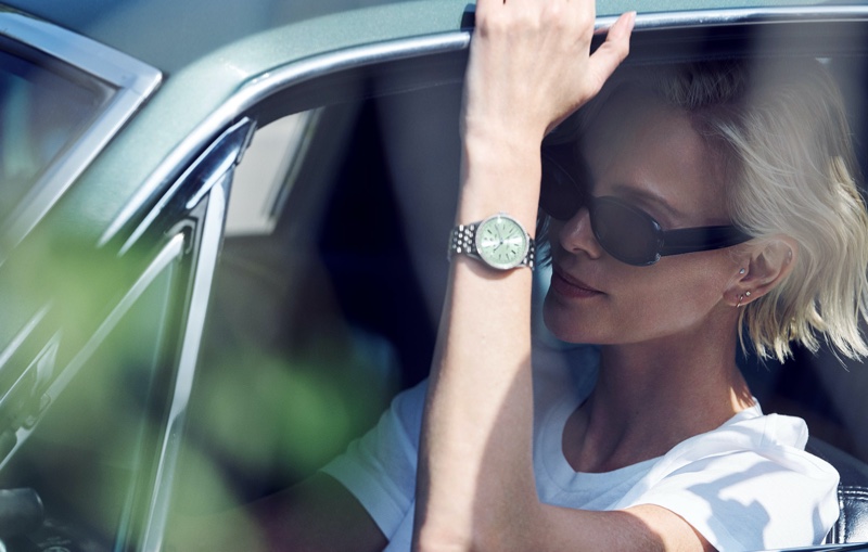 Taking a car ride, Charlize Theron poses for Breitling Navitimer 36 and 32 watch campaign.