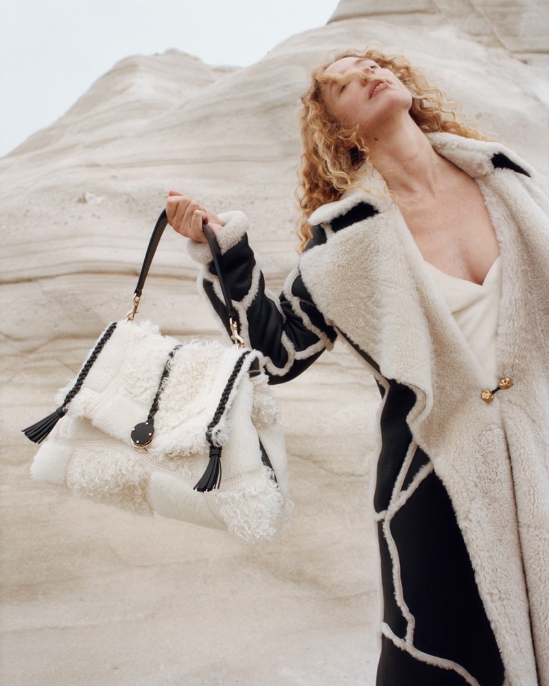 Raquel Zimmermann models shearling patchwork coat from Chloé fall 2023 campaign.