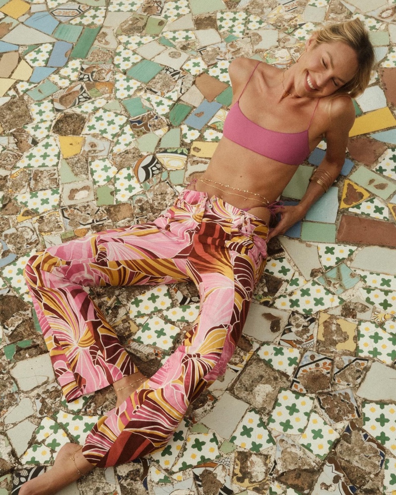 Photographed in Italy, Candice Swanepoel shows off a pink outfit for Tropic of C.