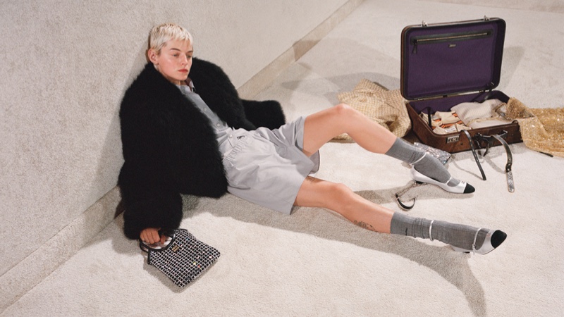 Emma Corrin shows off a faux fur coat in the holiday 2023 campaign from Miu Miu.