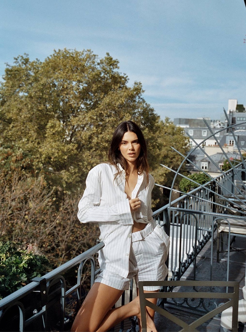 Wearing a striped top and shorts, Kendall Jenner poses in Paris for FWRD.