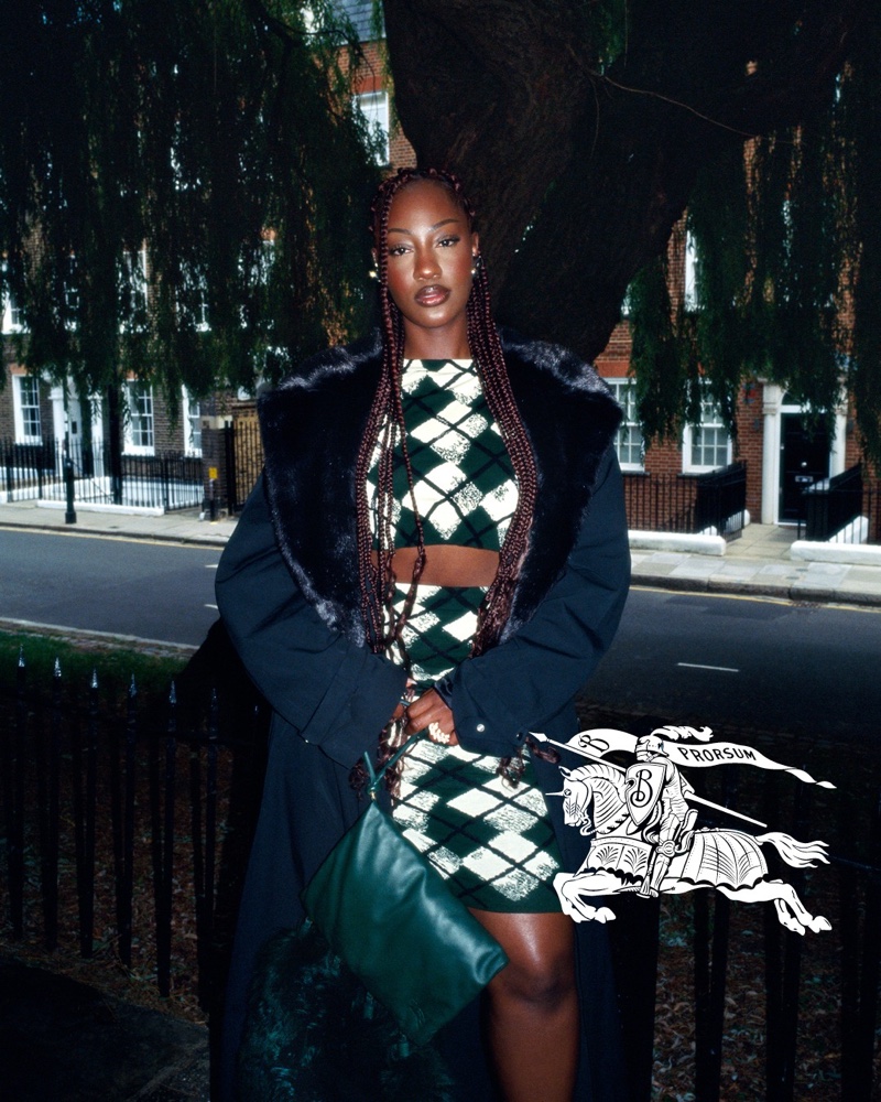 Tems rocks an argyle print with faux fur-trimmed coat for the Burberry spring 2024 advertising campaign.