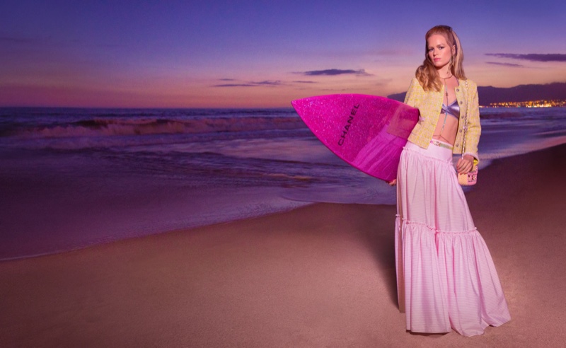 Chanel heads to the beach with a pink surf board for the cruise 2024 season.