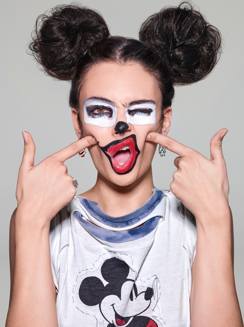 Deva Cassel captivates with playful artistry, sporting bold mouse-inspired makeup and hair with Mickey Mouse attire.