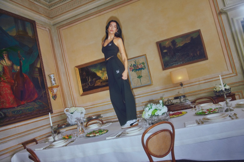 Clad in an all-black look, Dua Lipa poses in Italy for PUMA's Palermo advertisements.