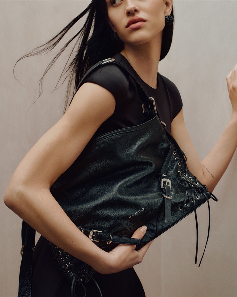 Effortless Edge: A dynamic snapshot featuring a sleek black Givenchy leather bag, embodying the modern and bold spirit of the 2023 holiday season.