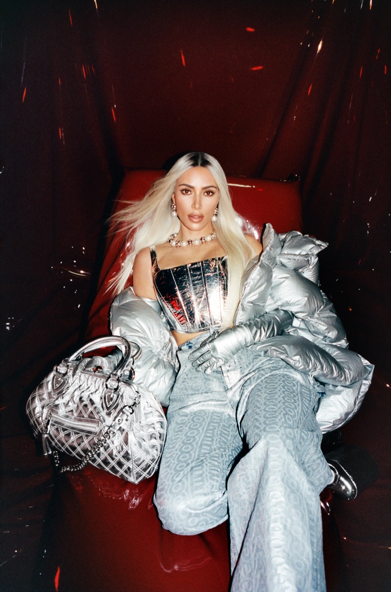 Turning up the shine factor, Kim K wears metallic corset top with jeans and silver accessories.