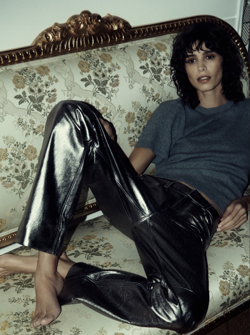 Mica Argañaraz lounges in casual glamour with metallic pants, bringing a relaxed yet sophisticated edge to the Massimo Dutti Evening 2023 trend guide.