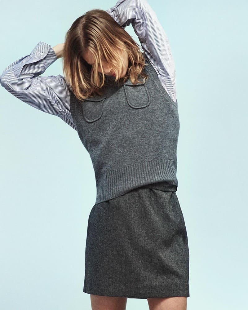 A playful twist on business casual from Massimo Dutti with a striped button-up shirt under a charcoal grey sweater vest paired with a mini skirt.