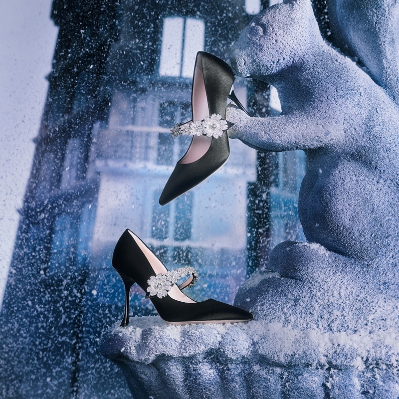 Roger Vivier's holiday spirit is crystallized in these elegant black pumps with floral embellishments, suspended in ice and snowflakes.