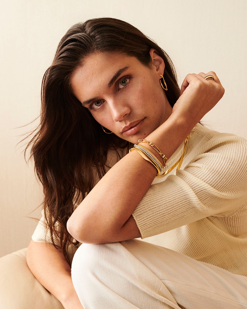 A vision in cream, Sara Sampaio highlights her sophisticated allure with Marco Bicego's gold jewelry, featuring a bold bracelet stack and hoop earrings.