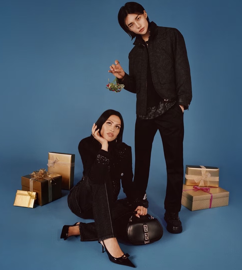 Versace features all-black outfits with wrapped gold gifts, capturing the stylish spirit of Versace's holiday 2023 vision.