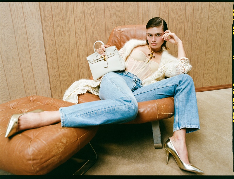 What Goes Around Comes Around features a cream crochet cardigan, classic blue jeans, and a compact white purse in holiday campaign.