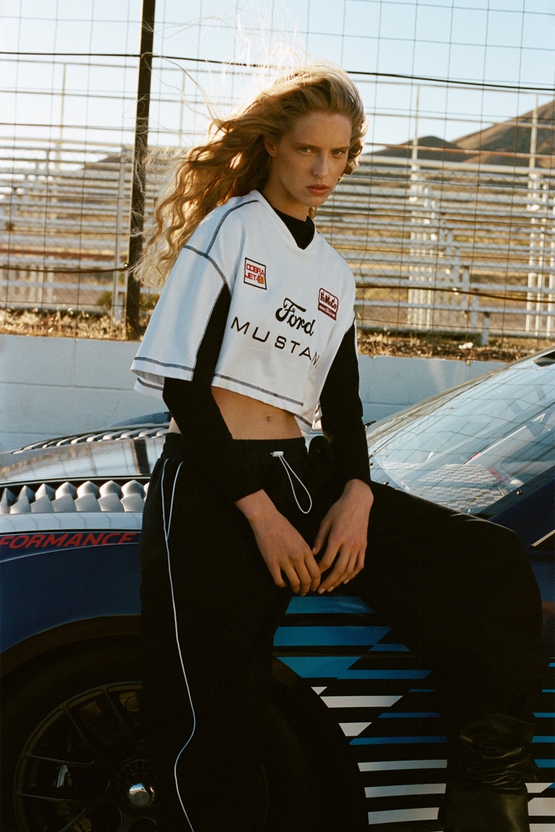 Abby Champion is trackside chic in a cropped Ford Mustang jersey, blending sporty vibes with casual chic for Zara.