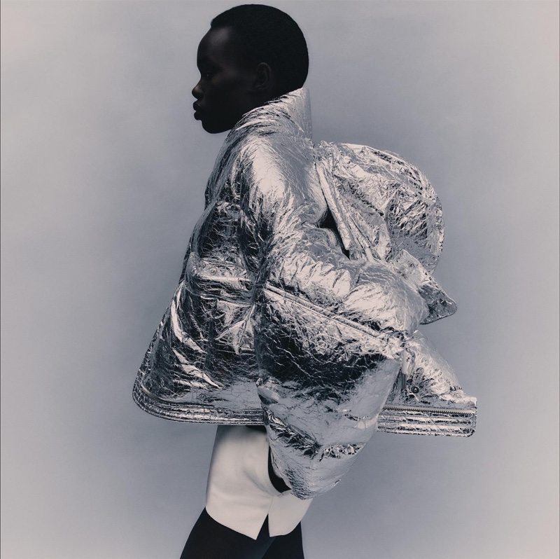 Reflecting winter's chill, Majda John Peter is enveloped in a silver, textured puffer jacket, a statement piece from AMI Paris's winter 2023 line.
