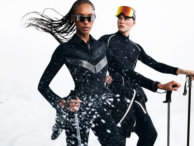 Cutting through the winter chill, models pose in sleek black ski suits from the BOSS x Perfect Moment fall-winter 2023 collection.