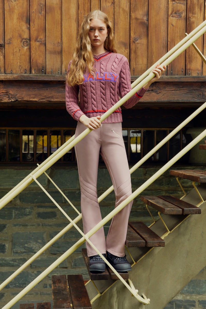 Retro shades of the 1970s stand out with a knitted pink sweater and chic mauve pants from Bally's winter 2023 Mountain capsule.