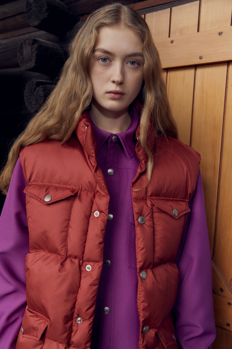 Layering for the cold, model Isabel Raven wears a purple shirt under a plush red puffer vest from the Bally winter 2023 capsule collection.