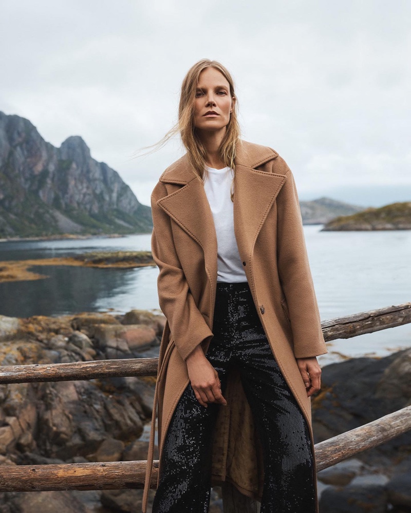 Suvi Riggs Koponen wears a camel coat layered over a crisp white tee and sequined pants for Banana Republic's winter 2023 campaign.