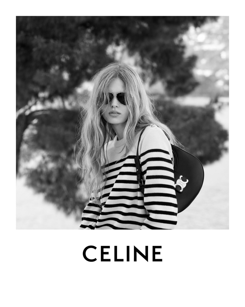 Channeling a nautical spirit, Celine's Les Grandes Classiques 07 collection showcases casual luxury with a striped sweater and statement sunglasses.