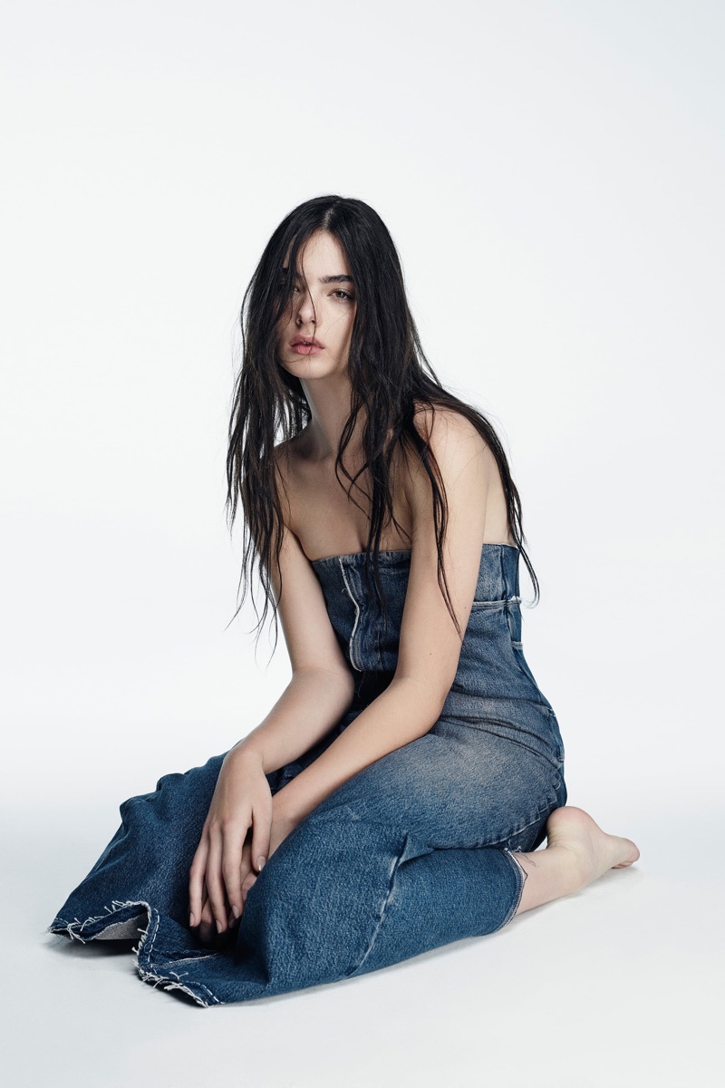 Channeling retro vibes, Deva Cassel lounges in a denim strapless dress from Zara's winter capsule collection.