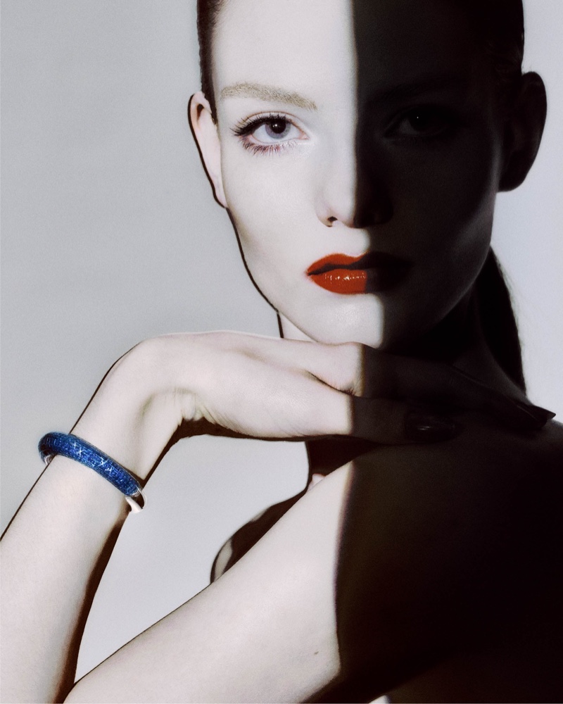 Alyda Grace dazzles in a blue bracelet and bold red lip color for Giorgio Armani Privé's Haute Joaillerie collection.
